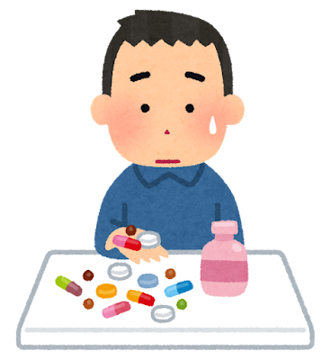 沢山の薬を飲むのを躊躇っている男の人